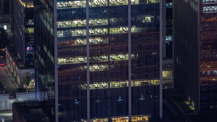 Windows in offices of a high class building at night timelapse