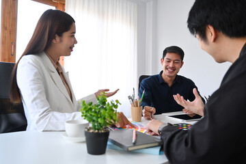 Group of interior designers  brainstorming, discussing on new project together.