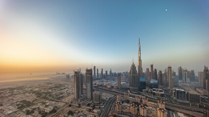Aerial view of tallest towers in Dubai Downtown skyline and highway timelapse.