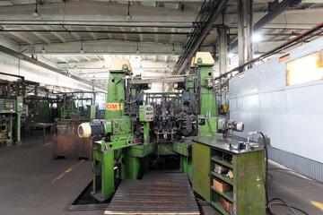 The interior of a big industrial building of factory with steel constructions. Plant of car production. Industrial and machinery concept