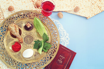 Pesah celebration concept (jewish Passove holiday). Traditional plate text in hebrew: Passover, horseradish, celery, egg, bone, maror, sweet dates jam