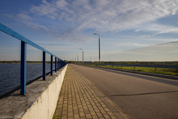 Road across the bridge over a large body of water.