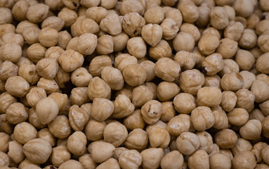 Hazelnut texture Background. Heap of peeled hazelnuts. Market stall with nuts. Flat lay, stock photo