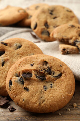Delicious chocolate chip cookies on wooden table, closeup