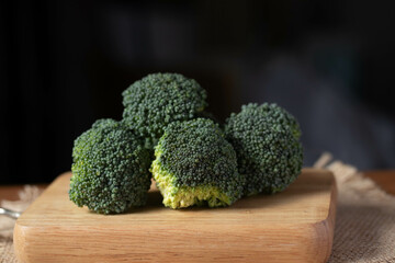 fresh broccoli on wooden background healthy or vegetarian food concept