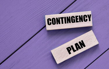 CONTINGENCY PLAN - words on wooden block on a purple background - obrazy, fototapety, plakaty