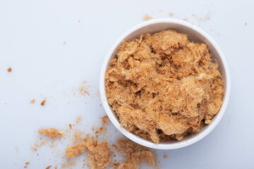 dried shredded pork in a white ceramic cup