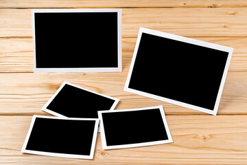 Blank photo frames for your photos on wooden background