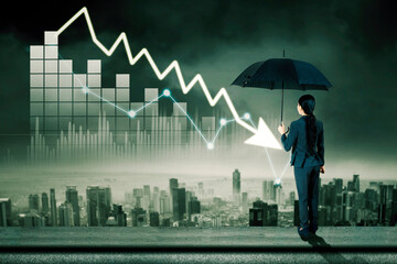 Woman holds umbrella and looks at declining arrow