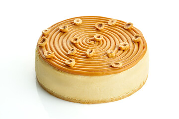 Cheesecake with caramel and nuts on a white background