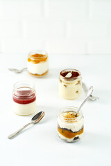 Cakes in jars on a white background. Sweet desserts