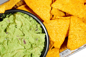 Mexican nachos with avocado guacamole on a white background. Hard Light