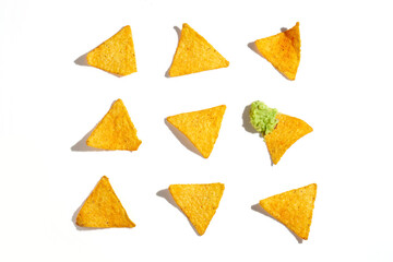 Mexican nachos with avocado guacamole on a white background. Hard Light. Pattern