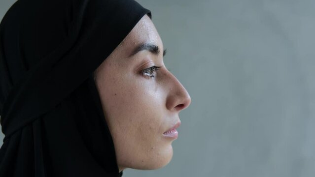 Profile of an Arab woman with beautiful features. Portrait of a Muslim woman in a black hijab. Muslim women in the media industry, actresses playing the role of oriental women.