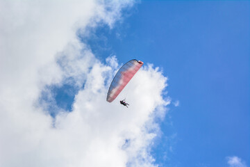 Paraglider flying over Himalaya mountains in summer day 
