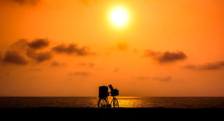 Beautiful Bike Silhouette, Beach sunset in the rocky beach of Someshwar, Mangalore, Karnataka, India