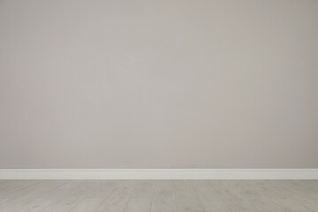 Blank light grey wall in room. Space for design