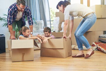 Fototapeta na wymiar Making moving day a family friendly activity. Shot of a happy family having fun together on moving day.