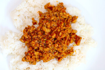 White plate with rice and cooked minced meat.