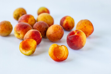 Ripe and tasty apricots on a white background