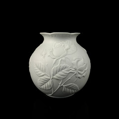 antique white porcelain vase in on a black isolated background. antique ceramic vase with stucco