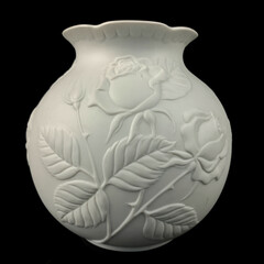 antique white porcelain vase in on a black isolated background. antique ceramic vase with stucco