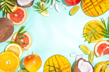 Summer fruits background. Various tropical fruits on turquoise background - mango, coconut, apples, avocado, lemon, orange, grapefruit, pineapple, with palm leaves. Colorful frame, banner flatlay