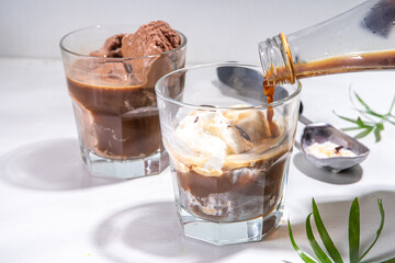 Summer cold cocktail. Amaro floats with chocolate and vanilla ice cream. Affogato Coffee latte with ice cream drink. Copy space on a white table