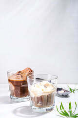 Summer cold cocktail. Amaro floats with chocolate and vanilla ice cream. Affogato Coffee latte with ice cream drink. Copy space on a white table