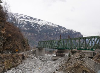 Steel bridge under construction over a dried-up river in Solang Valley, Himalayas