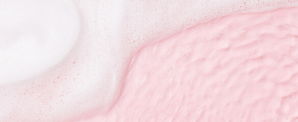 Top view of pink transparent clear calm water surface. Texture with splashes, foam and bubbles....