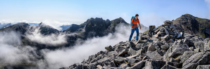 Woman with backpack walking on rocky mountain