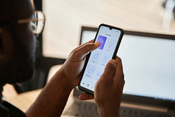 Young man using home automation app on smart phone