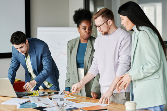 Multi-ethnic group of business colleagues planning strategy for new project in office