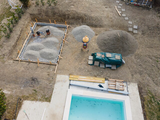 Drone shot of pool construction site with sheeting and gravel for a concrete pad for pool house in...