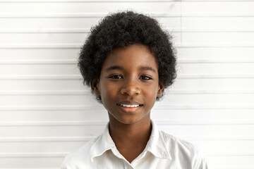 Portrait of cute adorable little african american boy smile looking at camera on a white background