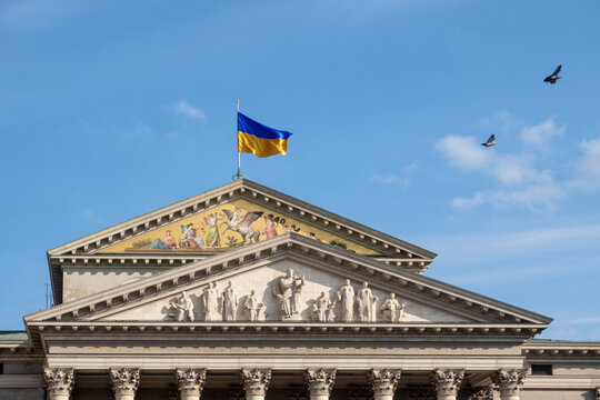 Germany, Bavaria, Munich, Ukrainian flag fluttering on roof of Residence Theatre