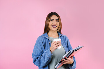 young hispanic business or student woman smiling at camera on pink background in Mexico Latin America	