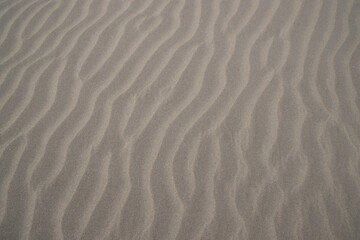 Fototapeta na wymiar sand texture. wavy sand textured background. sand textured beach.