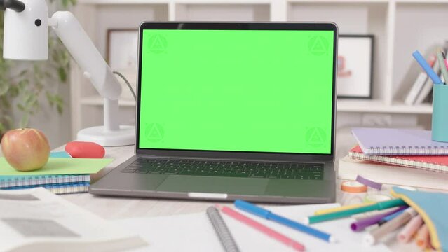 Laptop Computer with Green Screen in Cozy Student Room Interior