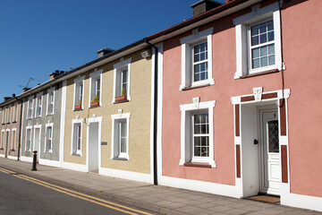 Back street in Aberaeron town on a sunny blue sky day. Yellow lines on the road prevent cars parking.