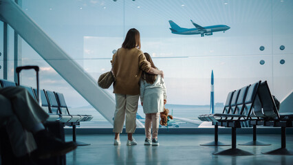 Airport Terminal: Beautiful Mother and Cute Little Daughter Wait for their Vacation Flight, Looking...