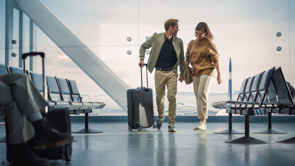 Airport Terminal Family Reunion: Beauitful Couple Meets at the Boarding Lounge. Smiling Girlfiend Meets the Love of Her Life after Long Parting and Hugs and Dances with Her Handsome Partner