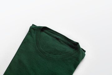 Close up shot of folded dark green t-shirt with white background