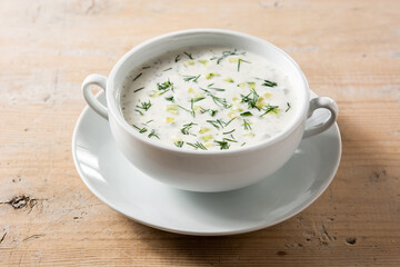 Bulgarian tarator sour milk soup in bowl on wooden table