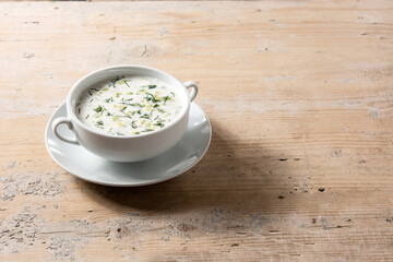 Bulgarian tarator sour milk soup in bowl on wooden table.Copy space
