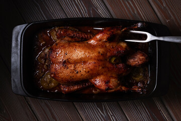 Duck baked in beer with vegetables in casserole