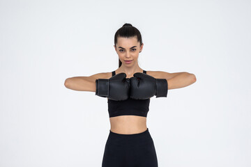 Fototapeta na wymiar Portrait of a young female boxer punching on white isolated background with copy space.