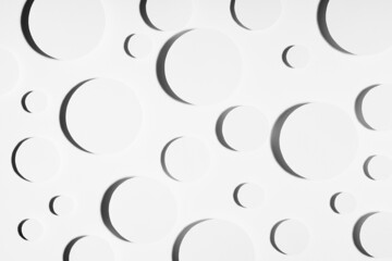 Geometric pattern of white circles in hard light with strict black contrast shadows in random, top...