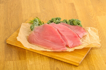 Raw salted tuna slice over board